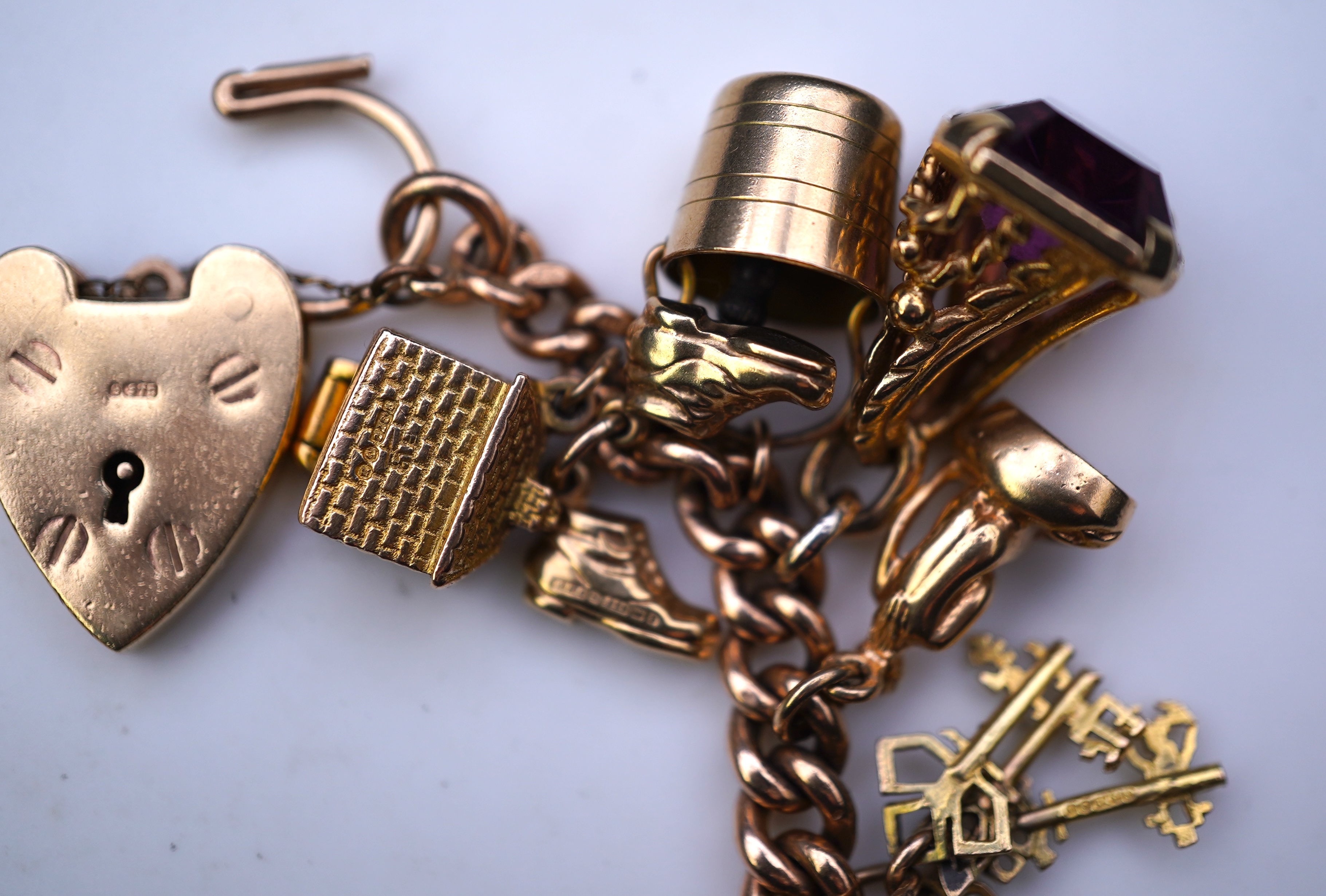A 9ct gold charm bracelet, mid 20th century